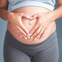 Mom holding pregnant belly