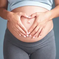 Mom holding pregnant belly