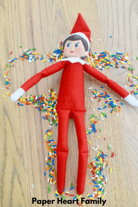 This Elf on the Shelf has the right idea. Making a sprinkle angel is much more fun!