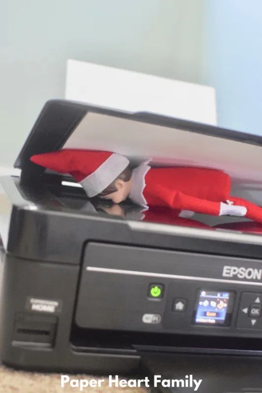 Silly Elf on the Shelf is trying to scan and print himself!
