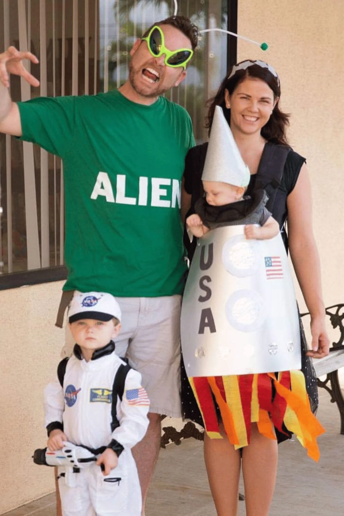 Father as an alien, little boy as an astronaut and mom wearing the baby who is a rocket.