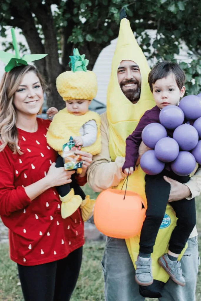 Mom as a strawberry, dad as a banana, kids as a pineapple and grapes