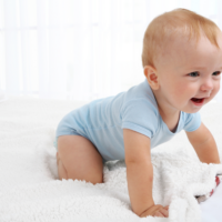 Baby boy crawling and laughing