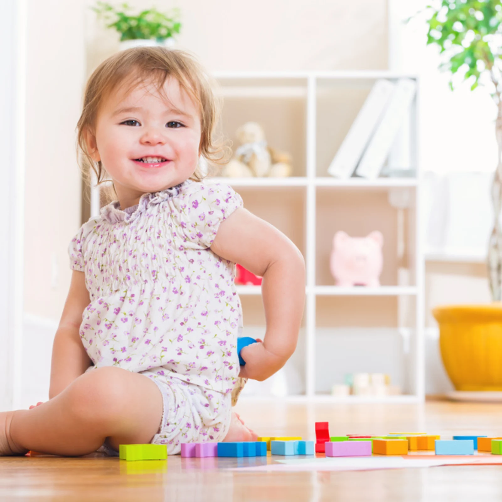 Two year old girl playing with blocks