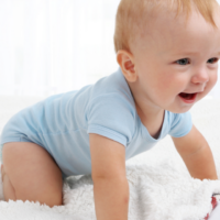 Baby boy crawling and laughing