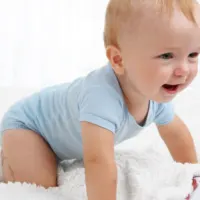 Baby boy crawling and laughing