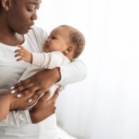 African American mom soothing baby
