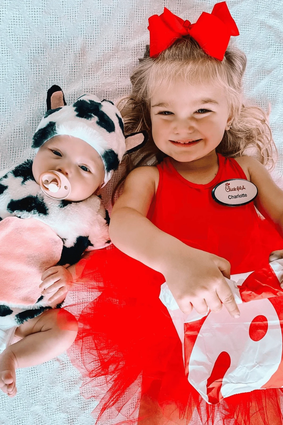 Baby dressed as a cow and toddler dressed as a Chik-Fil-A worker