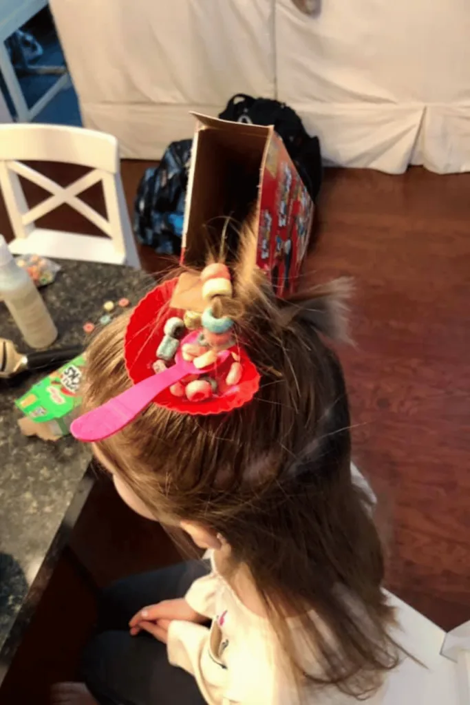 Mini fruit loop box, mini bowl and spoon in child's hair