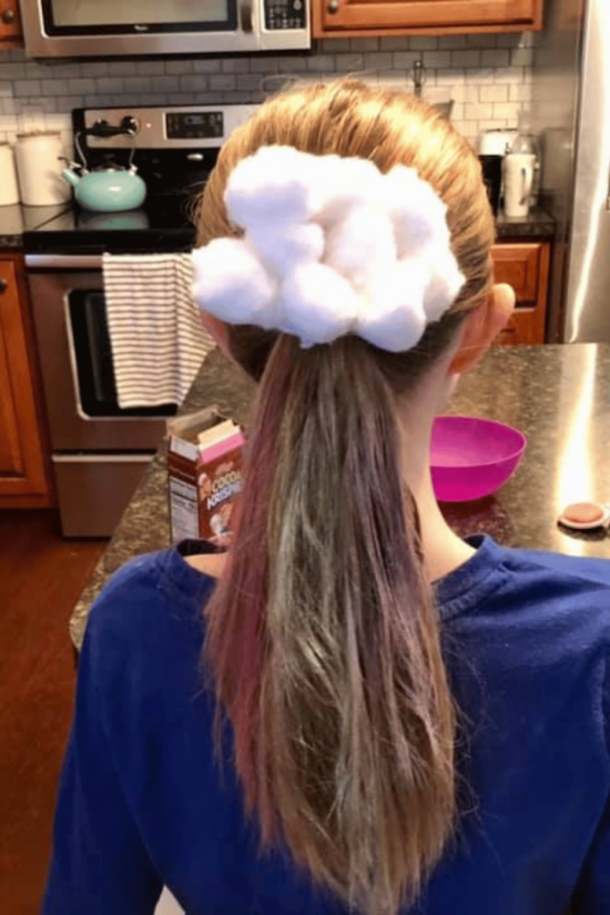 Cotton ball rainbow with a ponytail with rainbow colors using hair chalk