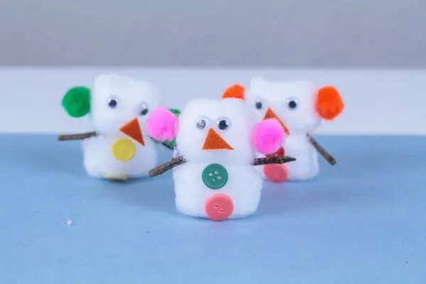 Snow men made out of cotton balls, buttons, felt and pom poms