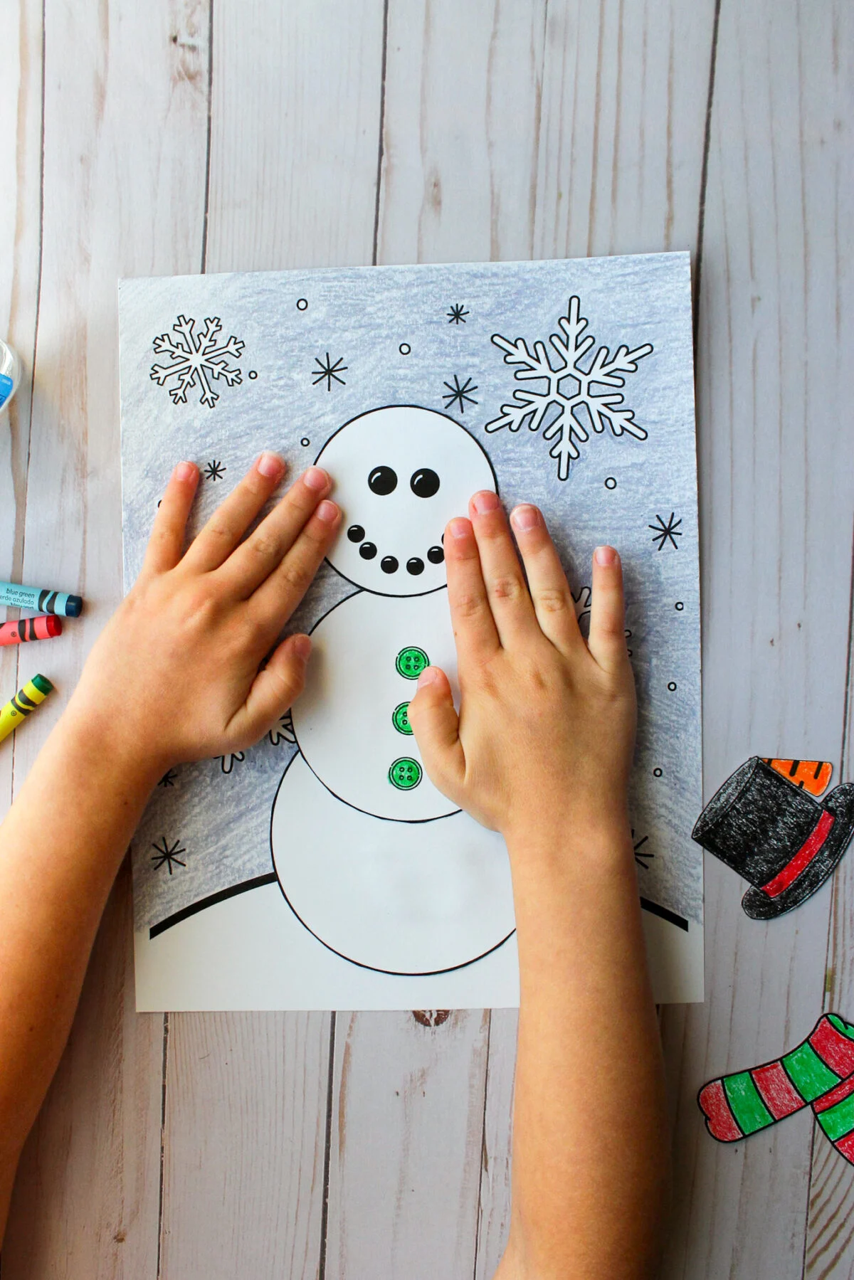 Child pasting the head on the snowman