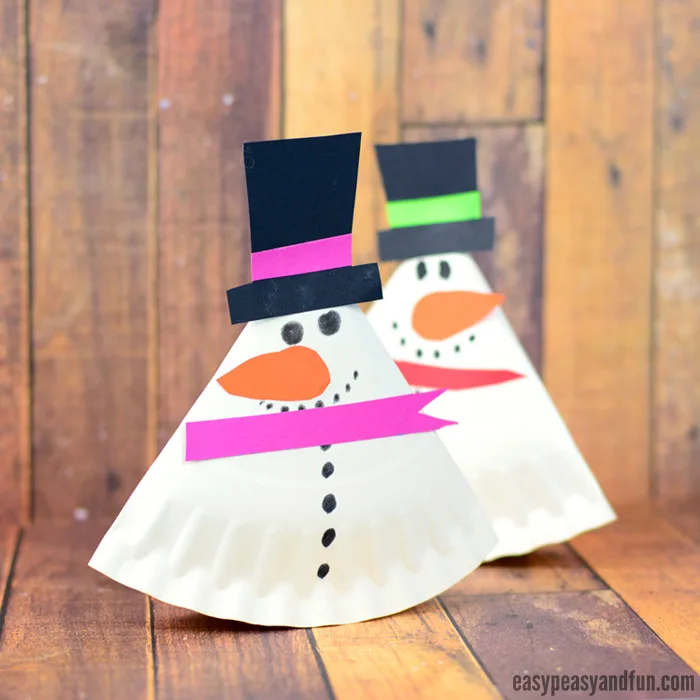 Snowman made out of a folded paper plate and construction paper