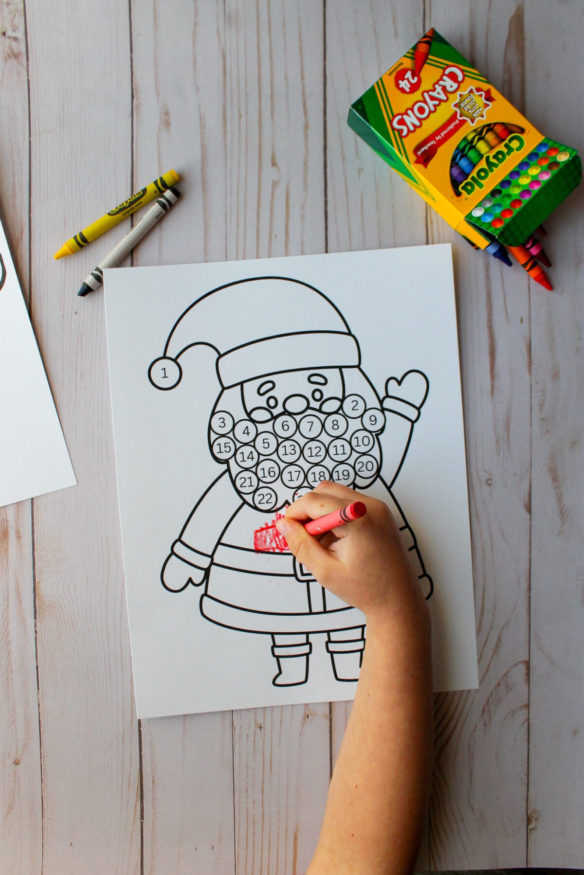 Child coloring Santa's suit red