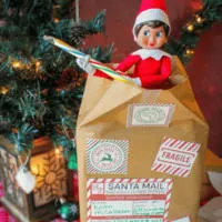 Elf on the Shelf bursting out of box shipped from the North Pole