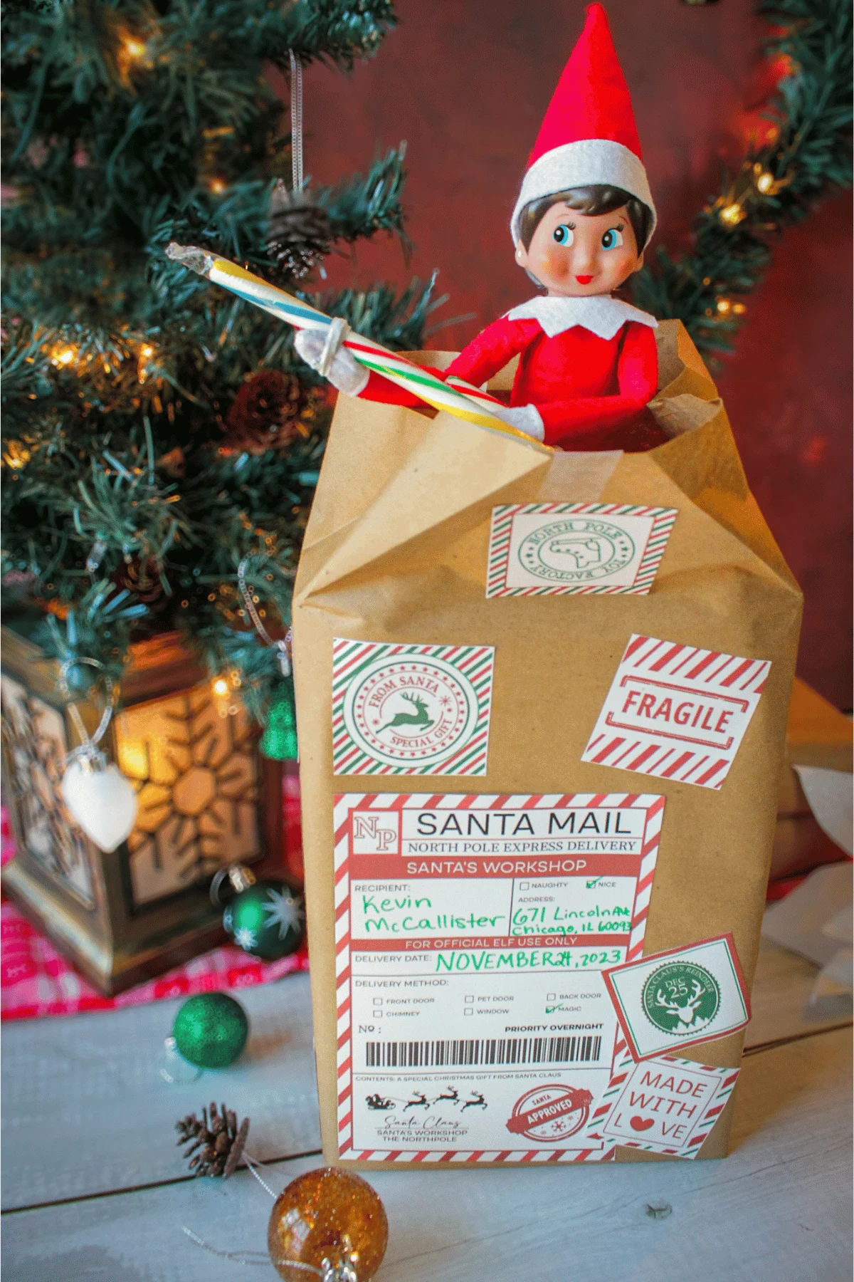 Elf on the Shelf bursting out of a box holding a candy cane