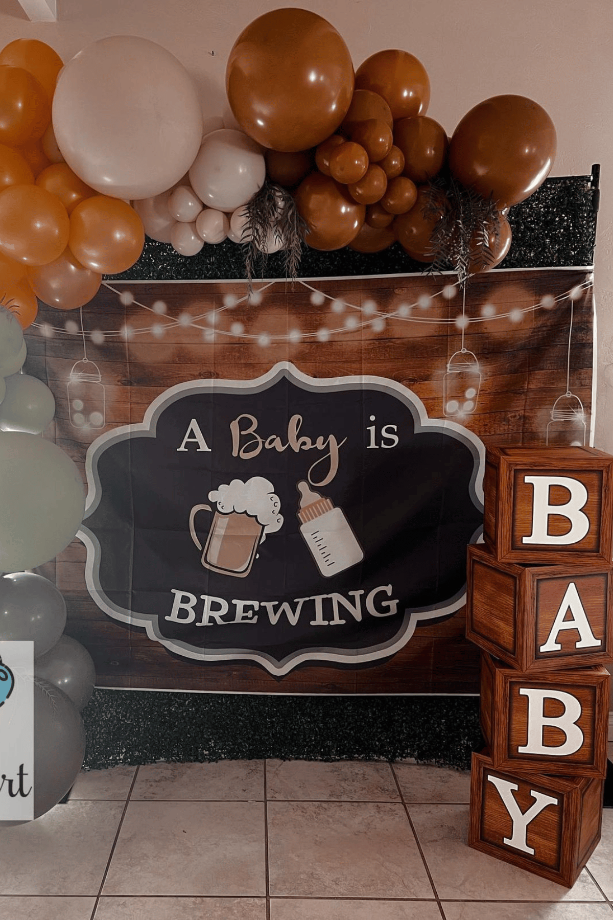 shower sign with a glass of beer and a baby bottle that says "a baby is brewing"