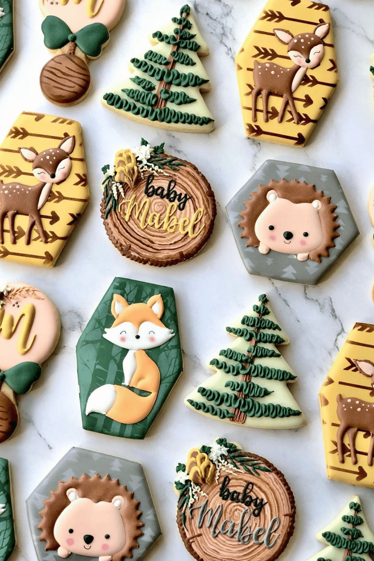 woodland themed cookies with hedgehogs, foxes and pine trees